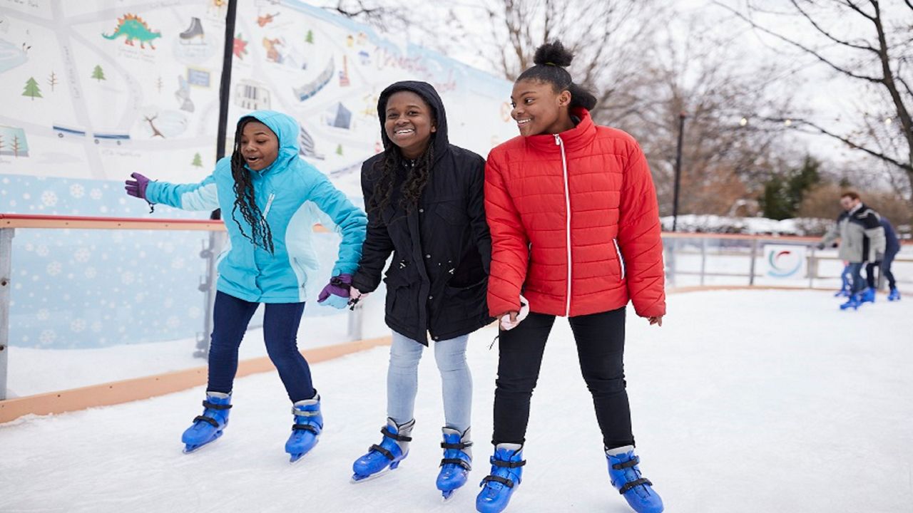 Three girls ice skating