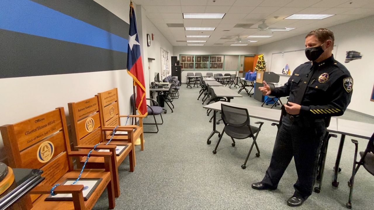 Chief of Police Jeff Spivey explaining the Briefing Chair memorial at the department. (Spectrum News/Lupe Zapata)