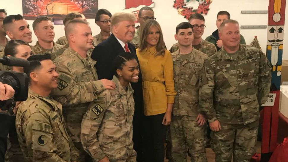 President Donald Trump and first lady Melania Trump pose with troops in Iraq in this picture posted to Twitter by the White House press secretary. (@PressSec on Twitter)