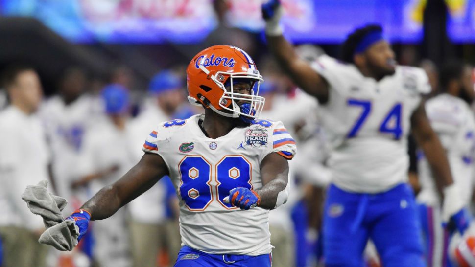 Florida tight end Kemore Gamble (88) and Florida offensive lineman Fred Johnson (74) celebrate after the Peach Bowl NCAA college football game against Michigan, Saturday, Dec. 29, 2018, in Atlanta. Florida won 41-15. (AP Photo/Mike Stewart)