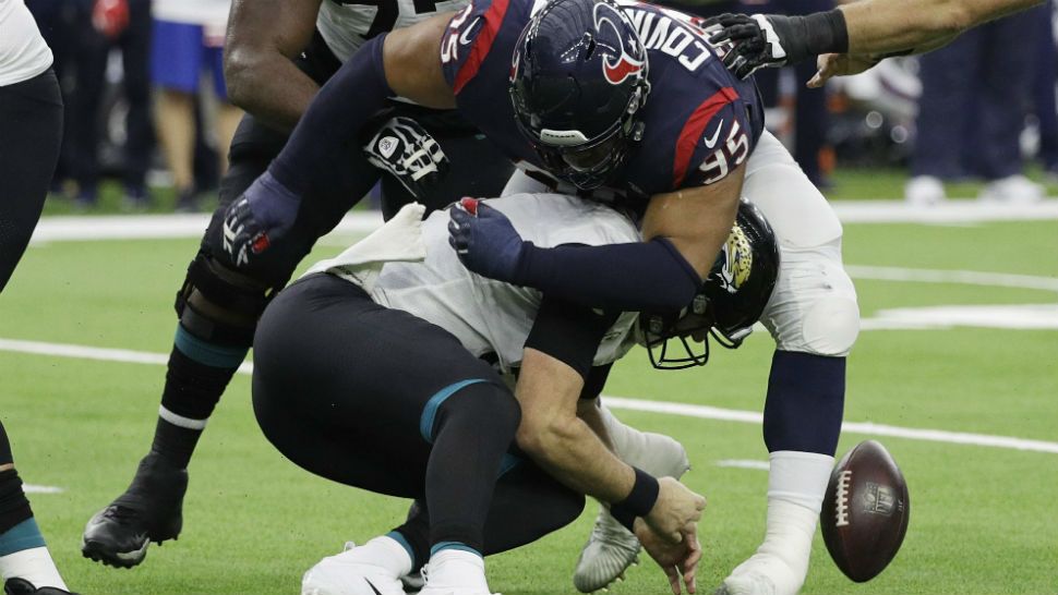 Houston Texans defensive end Christian Covington (95) hits Jacksonville Jaguars quarterback Blake Bortles (5) causing a fumble during the first half of an NFL football game, Sunday, Dec. 30, 2018, in Houston. Jacksonville recovered the ball. (AP Photo/David J. Phillip)