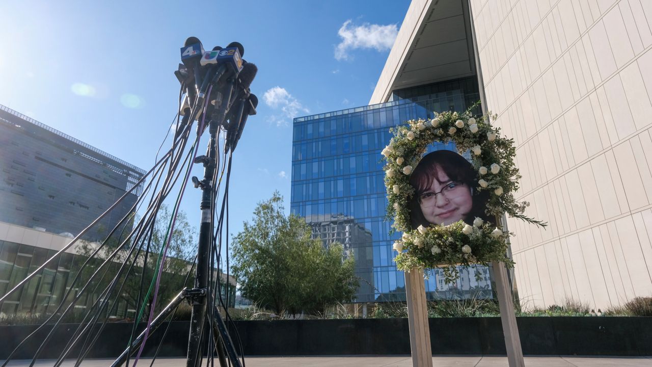 A wreath with a picture of Valentina Orellana-Peralta, is displayed at a news conference outside Los Angeles Police Department Headquaters in Los Angeles, Tuesday, Dec. 28, 2021. (AP Photo/Ringo H.W. Chiu)