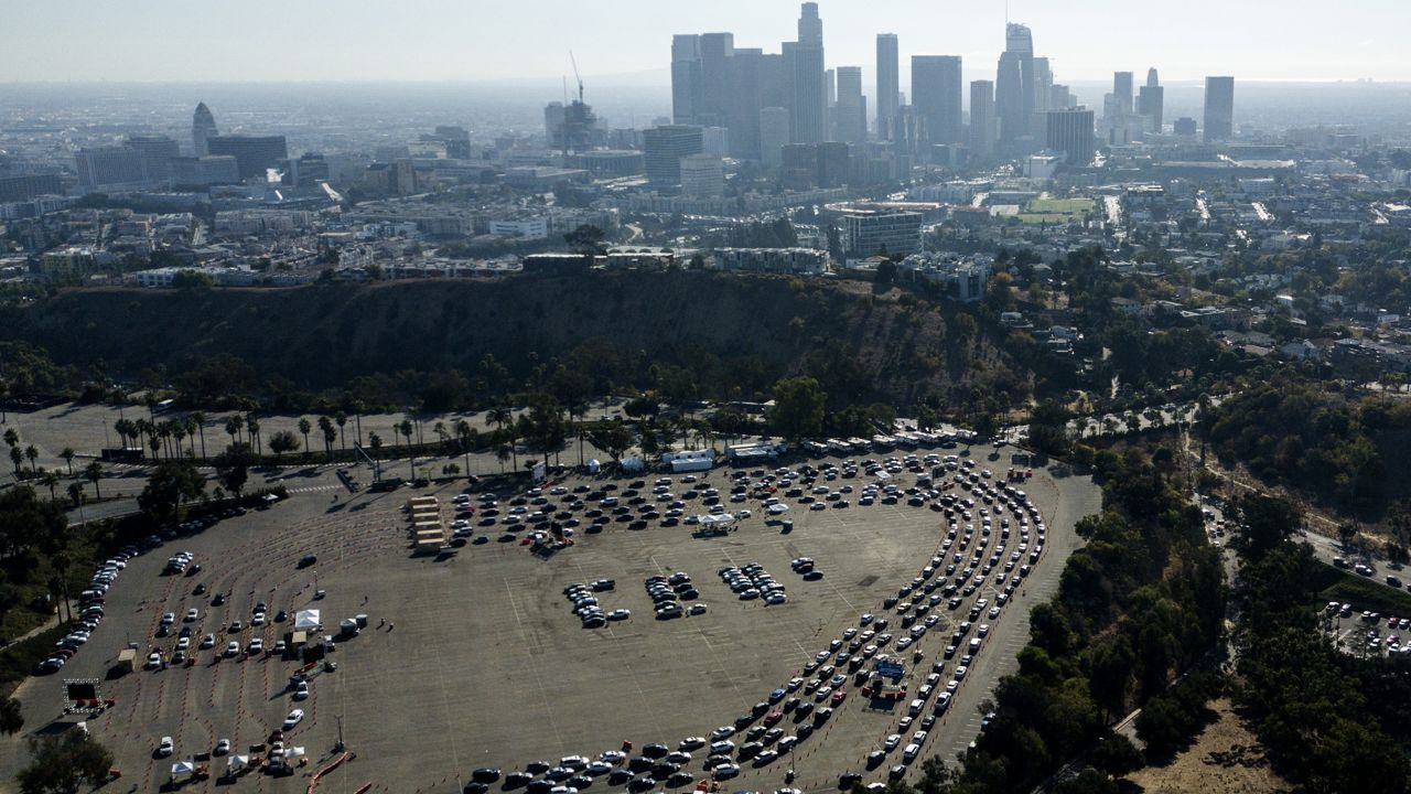 Long lines of motorists wait to take a coronavirus test at Dodger Stadium in Los Angeles on Nov. 18, 2020. (AP Photo/Ringo H.W. Chiu)