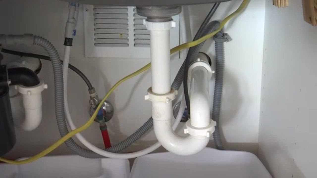 Generic picture of pipes under a sink.
