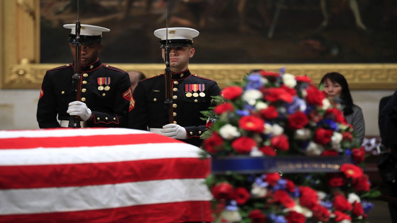 A final salute is rendered by the honor guard standing watch over the flag-draped casket of the late president, George H.W. Bush, as the public viewing comes to an end at the U.S. Capitol Rotunda, Wednesday, Dec. 5, 2018. (AP Photo/J. Scott Applewhite)