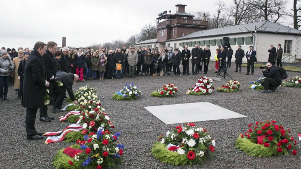Mourners put wreaths around marker at the Buchenwald concentration camp for Holocaust Remembrance Day