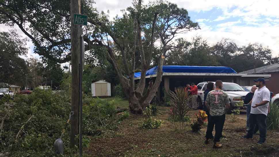 The owners of RedTree Landscape Systems wanted to help with clean-up efforts following Sunday's tornado and the damage it did to a New Port Richey home. They offered to remove this damaged tree for free. (Sarah Blazonis/Spectrum Bay News 9)