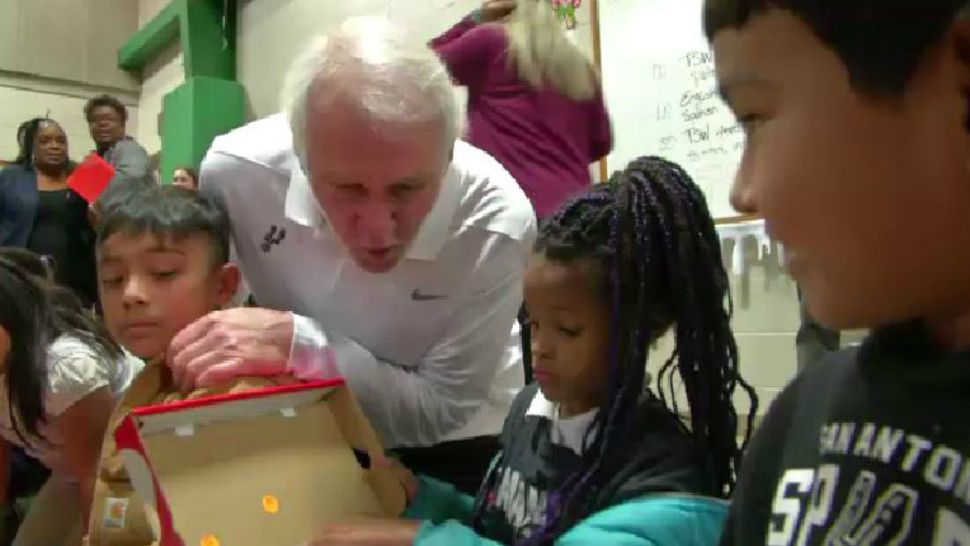 San Antonio Spurs coach Gregg Popovich delivers shoes to children in need. (Spectrum News footage)