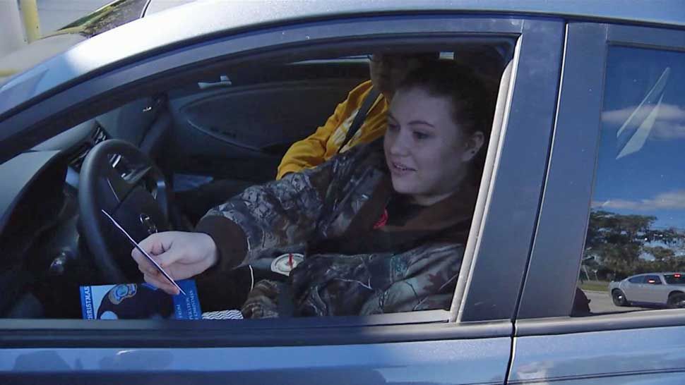 Driver Katheryn Krzyzanski was confused when Dade City Police pulled her over Tuesday afternoon. That confusion turned to elation when Sgt. Leroy Harrelson gave her a $50 Walmart gift card for her safe driving, as part of the department's "Operation: Blue Christmas."