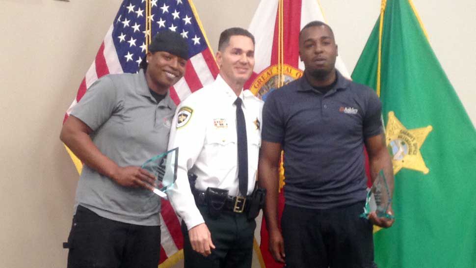 Left to Right: Jolisa Jones, 27, Hillsborough Sheriff Chad Chronister, and Aaron Allen, 29. Jones and Allen received awards from the Sheriff on Wednesday, December 12, 2018, for their life-saving actions earlier this year. (Josh Rojas/Spectrum Bay News 9)