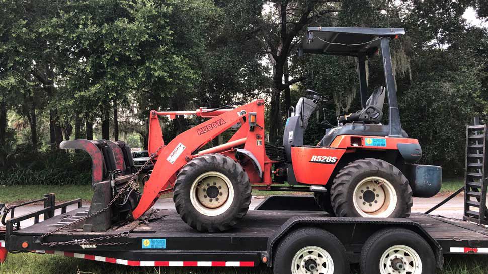 Southern Tree & Excavation said they found this front-end loader and equipment trailer missing from their equipment yard Friday morning. (Courtesy of Southern Tree & Excavation)