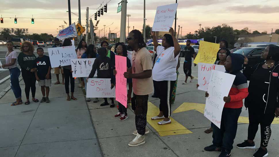Protesters gathered at the intersection of East Memorial Boulevard and North Florida Avenue in Lakeland Wednesday to protest the shooting death of Michael Taylor, 17. (Laurie Davison/Spectrum Bay News 9)