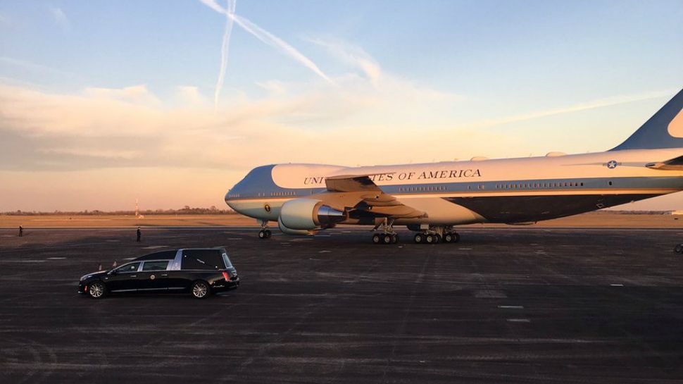 A hearse sits in front of the presidential aircraft at Ellington Airport (Spectrum News photograph)