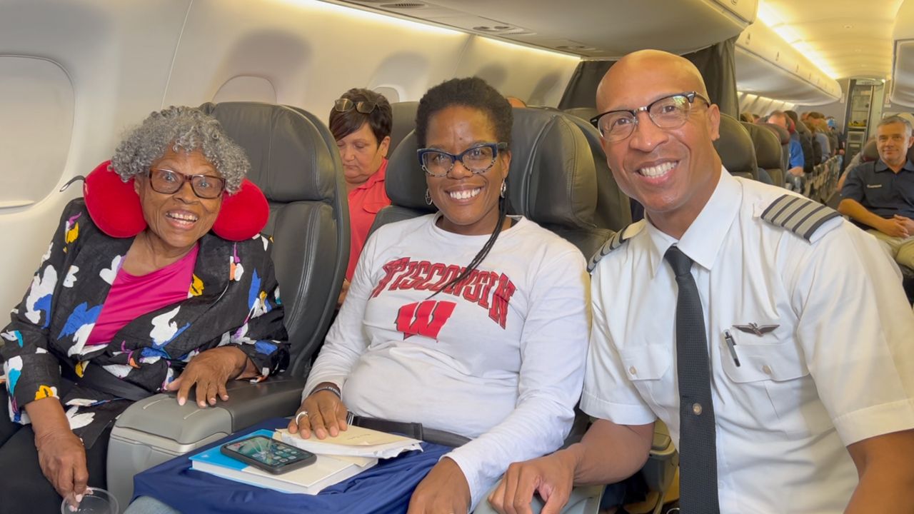 Opal with her Cousin Amani Latimer Burris and the captain who flew her back to Dallas from Alabama. He knew who she was immediately, and wanted to introduce himself personally. (Lupe Zapata/Spectrum News 1)