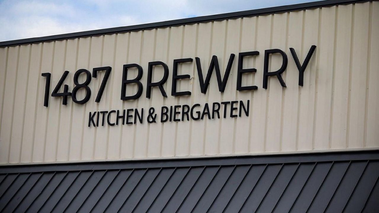 1487 Brewery Kitchen & Biergarten Logo on top of building