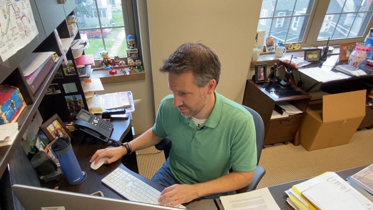 School administrator at desk.