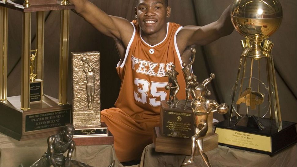 Kevin Durant poses with trophies won during his time as a UT men's basketball player. (Photo Courtesy: University of Texas)