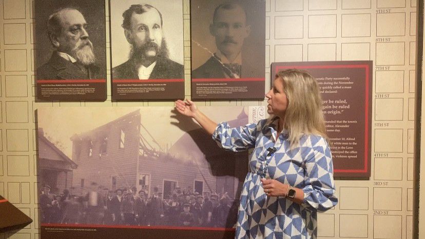 Cara Ward goes through the events of November 10, 1898. (Spectrum News 1/Natalie Mooney)