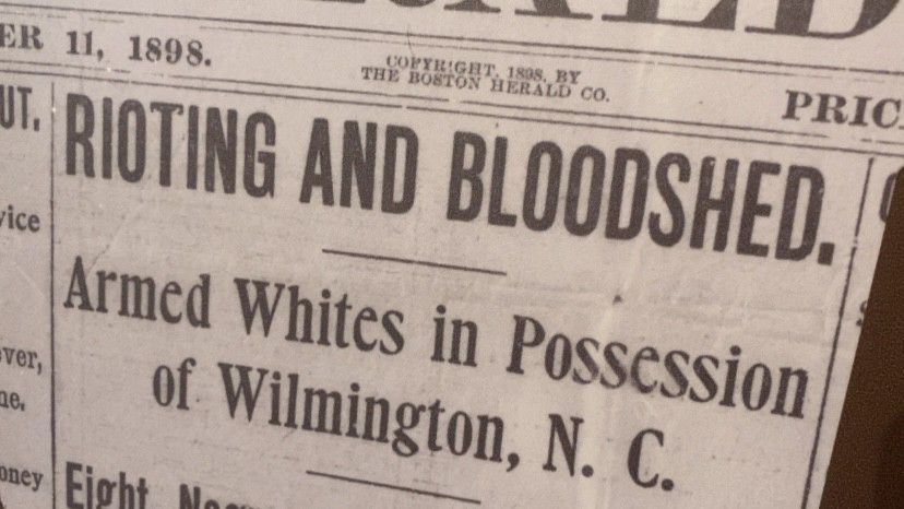 An old newspaper clipping describing the events of the 1898 Massacre on display at the Cape Fear Museum. (Spectrum News 1/Natalie Mooney)