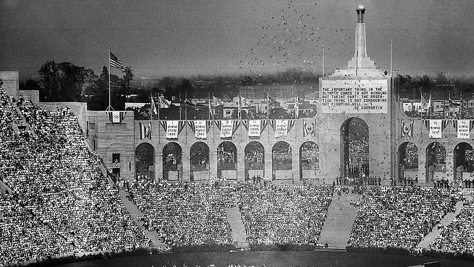 FILE - In this July 30, 1932, file photo, doves are released during the opening ceremony for the Tenth Olympiad at Los Angeles. The athletes of various countries are shown on the field while the Olympic beacon and the entrance to the stadium is shown in the background. (AP Photo/File)