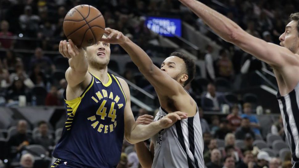 Indiana Pacers forward Bojan Bogdanovic (44) tries to shoot past San Antonio Spurs forward Kyle Anderson, center, and center Pau Gasol, right, during the first half of an NBA basketball game, Sunday, Jan. 21, 2018, in San Antonio. (AP Photo/Eric Gay)