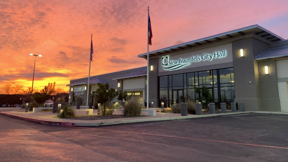 The sun sets behind New Braunfels City Hall (Spectrum News photograph)