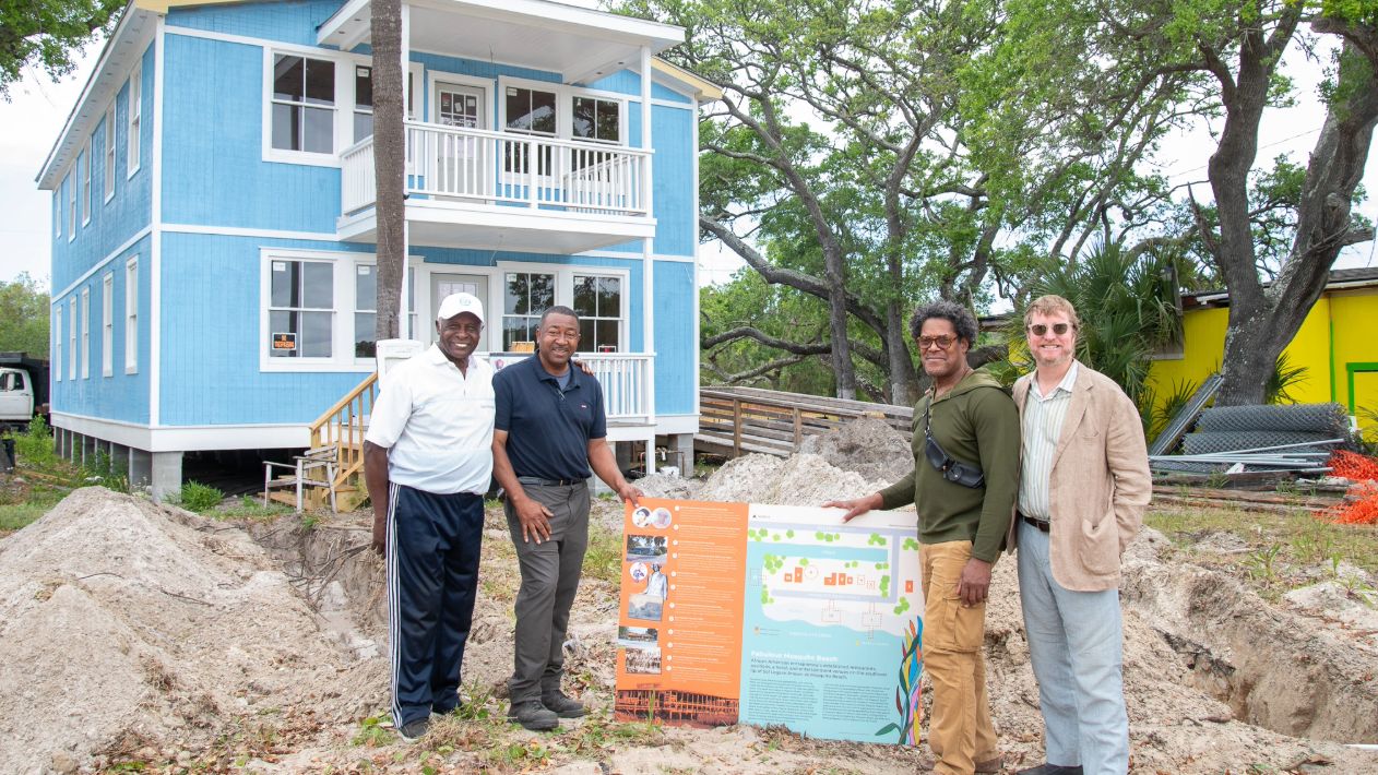 Leaders with the Historic Charleston Foundation stand before the Pine Tree Hotel on Mosquito Beach in James Island, South Carolina. (Photo/ Historic Charleston Foundation) 
