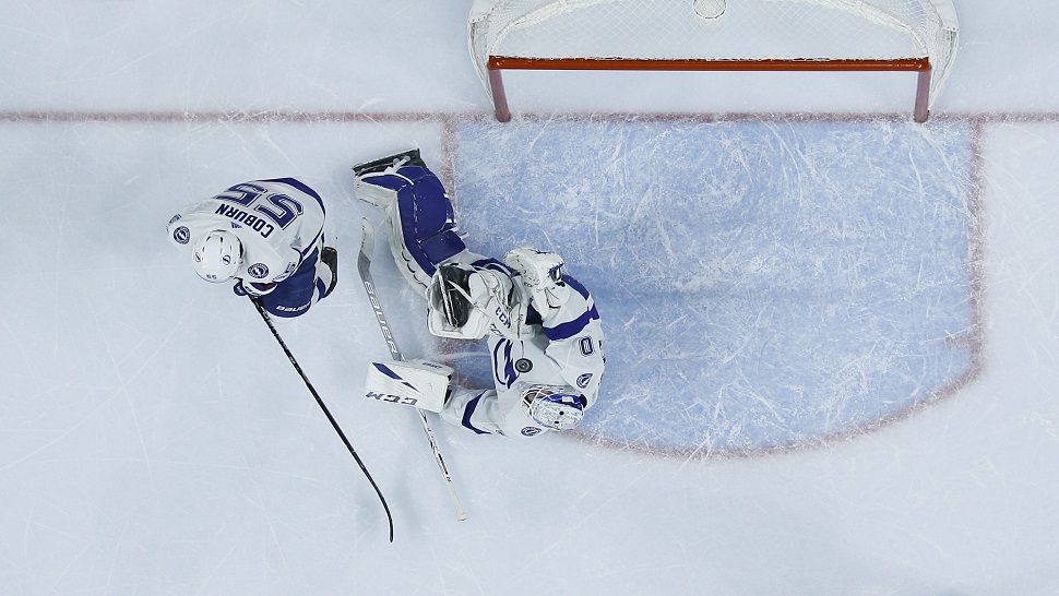 Lightning goaltender Louis Domingue (70) blocks a shot from the Flyers in Tampa Bay's 5-2 win Tuesday.  Domingue extended a franchise record with his 11th straight win.  (AP Photo/Matt Slocum)