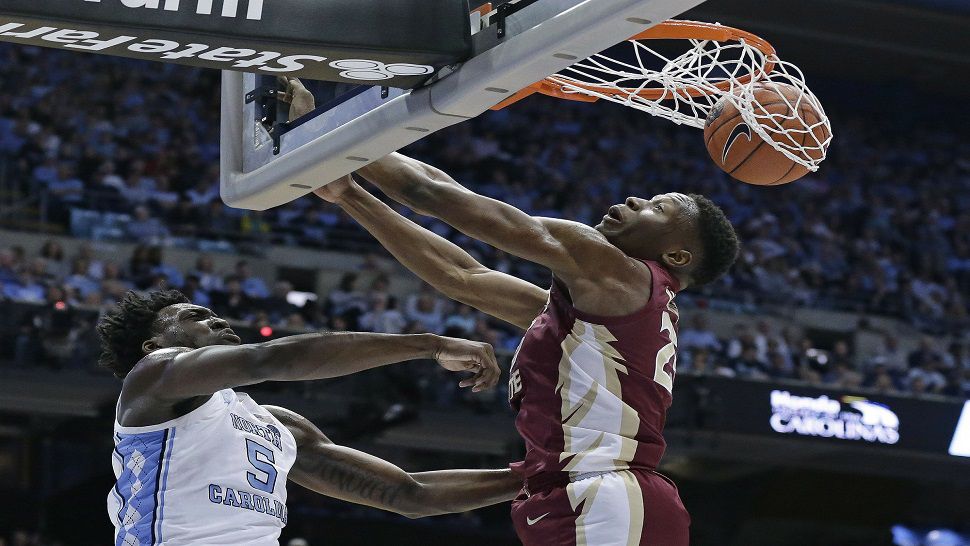 North Carolina's Nassir Little, left, throws dunk a dunk against Florida State's Mfioundu Kabengele during UNC's win over the Seminoles.  (AP Photo/Gerry Broome)