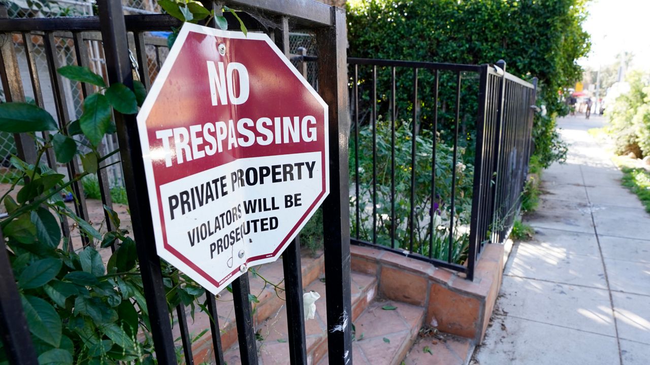 A No Trespassing sign appears on a gate near an area on North Sierra Bonita Ave. where Lady Gaga's dog walker was shot and two of her French bulldogs stolen in Los Angeles. (AP Photo/Chris Pizzello)