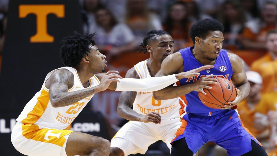 Florida guard Kevaughn Allen, right, is pressured by Tennessee guards Jordan Bowden (23) and Jordan Bone (0) in the first half of Florida's 73-61 loss to No. 1 Tennessee.  (AP Photo/Wade Payne)