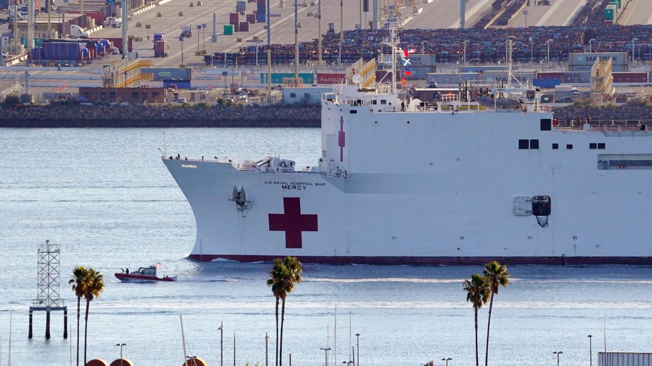 FILE - In this March 27, 2020, file photo, the US Naval Ship Mercy enters the Port of Los Angeles. The 1,000-bed USNS Mercy (T-AH 19) accepted its first patients in Los Angeles Sunday, March 29, 2020 during its support of the nation's COVID-19 response efforts. The new coronavirus causes mild or moderate symptoms for most people, but for some, especially older adults and people with existing health problems, it can cause more severe illness or death. (AP Photo/Mark J. Terrill, File)