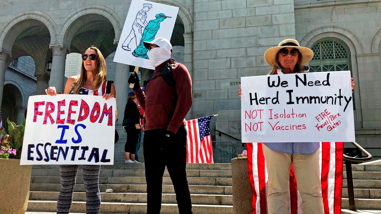 People urging the reopening of businesses during the coronavirus shutdown demonstrate in front of Los Angeles City Hall Friday, May 1, 2020. (AP Photo/Stefanie Dazio)