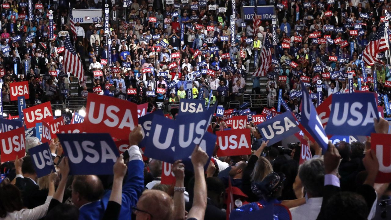 Voters hold signs during the Democratic National Convention in Philadelphia , Thursday, July 28, 2016. (AP Photo/Paul Sancya)