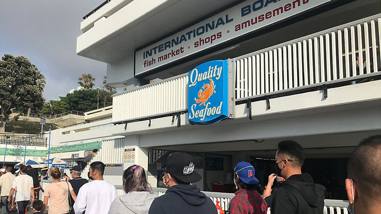 Customers stream past Redondo Beach's Quality Seafood.