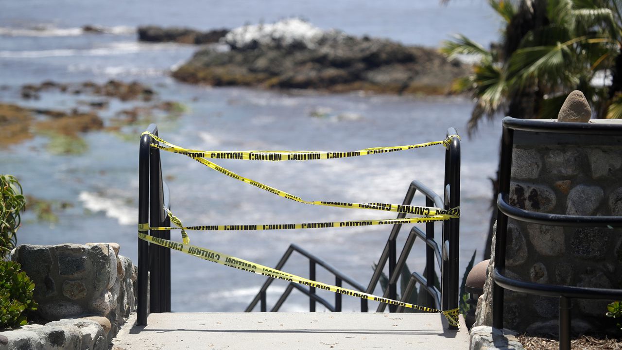 In this file photo, access to the beach is closed off on May 3, 2020, in Laguna Beach. In Orange County, where beaches were singled out for closure by the governor during the coronavirus pandemic, crowds were sparse as lifeguards and police patrolled and issued warnings to people to stay off the sand. (AP Photo/Marcio Jose Sanchez)