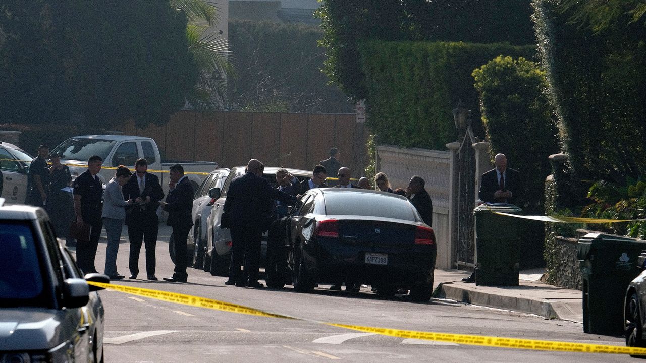 In this file photo, police officers and investigators work outside a Hollywood Hills home where a fatal shooting occurred on Feb. 19, 2020, in Los Angeles. (AP Photo/Ringo H.W. Chiu)