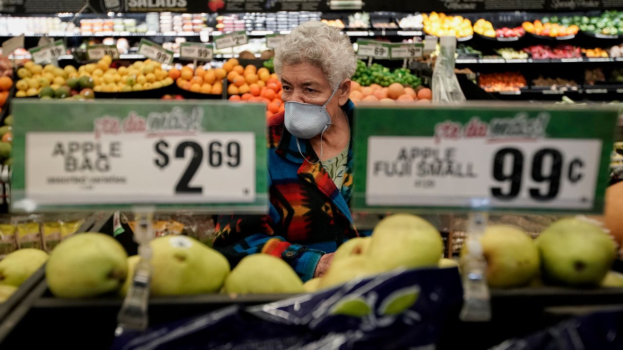 In this March 17, 2020 file photo, Carmen Zamora shops at Northgate González Market in Santa Ana, during early shopping time for those over 65 and the disabled. On Wednesday, Orange County health officials announced another 17 COVID-19 fatalities, raising the death toll over 600. Officials were asking residents to wear masks when going outdoors. (AP Photo/Chris Carlson)