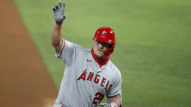 Los Angeles Angels' Mike Trout waves to the dugout after hitting a two-run home run in the first inning of a baseball game against the Texas Rangers in Arlington, Texas, Friday, Aug. 7, 2020. The shot scored David Fletcher. (AP Photo/Tony Gutierrez)