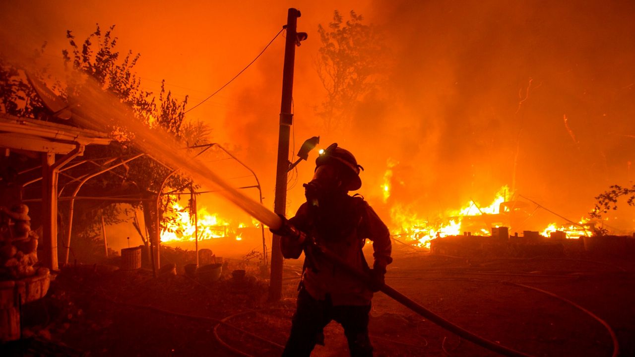 A firefighter works against the Lake Hughes fire in Angeles National Forest on August 12, 2020, north of Santa Clarita. (AP Photo/Ringo H.W. Chiu)