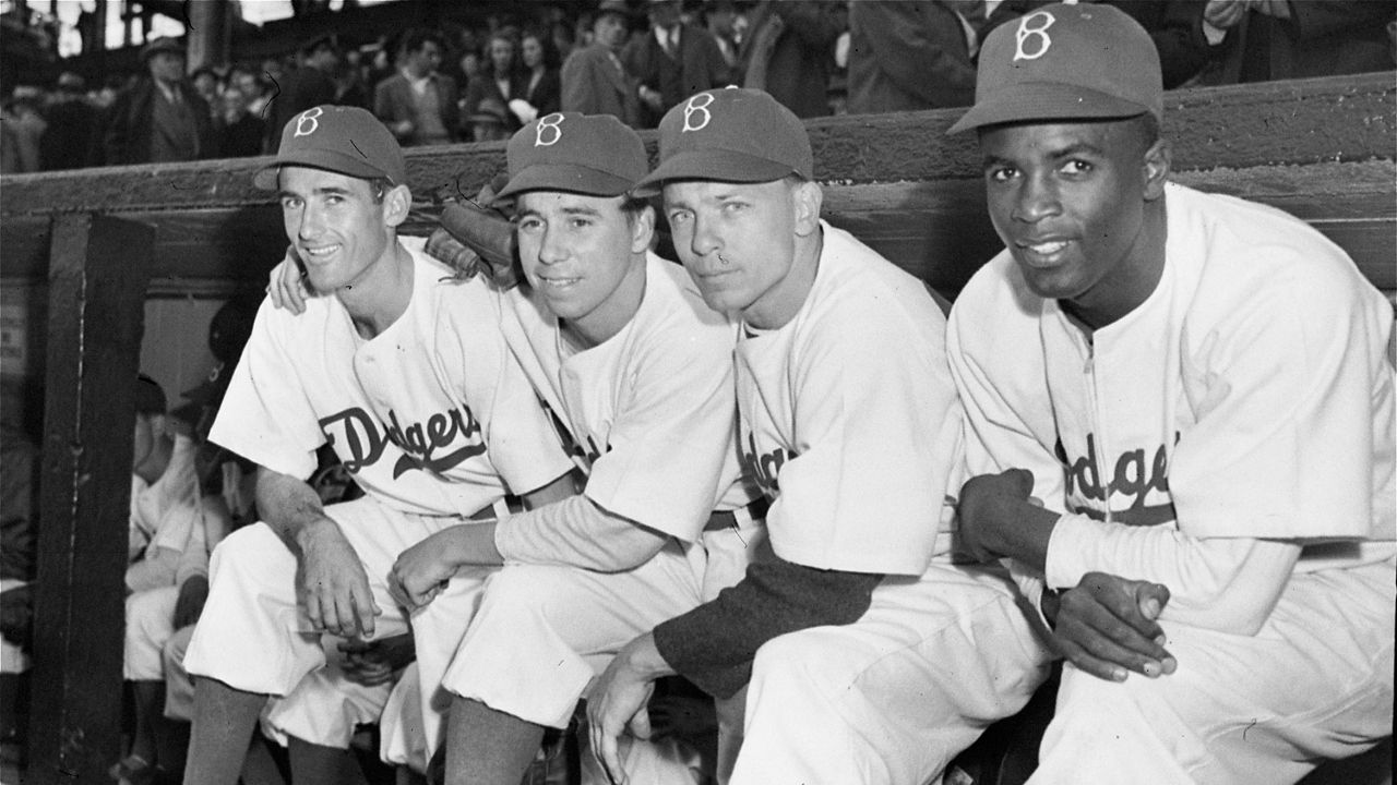 In this April 15, 1947, file photo, Brooklyn Dodgers baseball players, from left, third baseman John Jorgensen, shortstop Pee Wee Reese, second baseman Ed Stanky, and first baseman Jackie Robinson pose before the opener at Ebbets Field in New York. Robinson broke baseball’s color barrier on April 15, 1947, for the Brooklyn Dodgers and his No. 42 was retired throughout the major leagues in 1997 by then-Commissioner Bud Selig. An annual Jackie Robinson Day started in 2004. (AP Photo/Harry Harris)