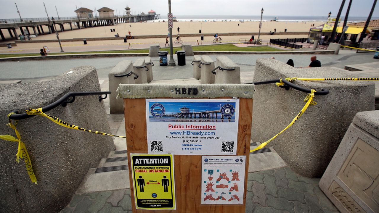 In this file photo from April 30, 2020, a sign gives social distance and handwashing guidelines in Huntington Beach. (AP Photo/Marcio Jose Sanchez)
