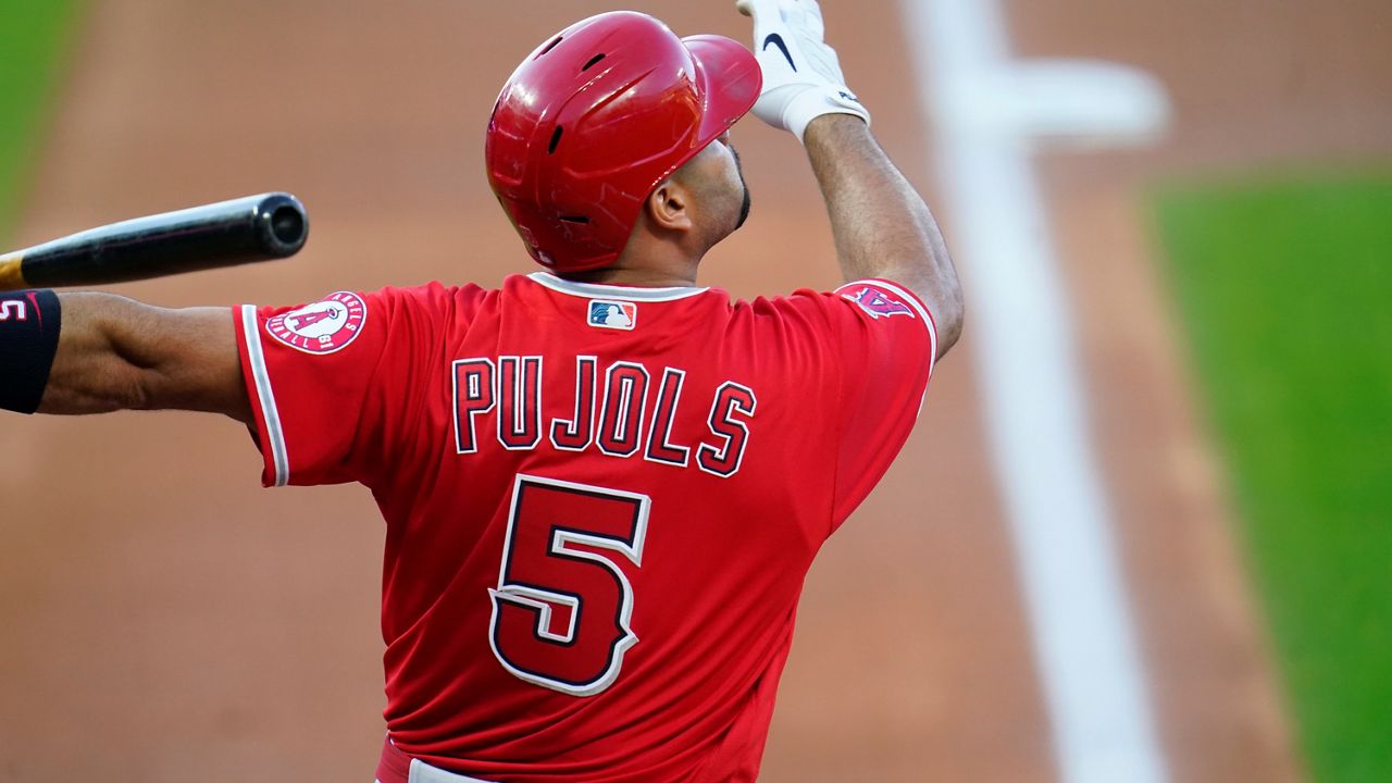 Los Angeles Angels designated hitter Albert Pujols follows the flight of his fly out against Colorado Rockies starting pitcher Kyle Freeland in the second inning of a baseball game Saturday in Denver. (AP Photo/David Zalubowski)