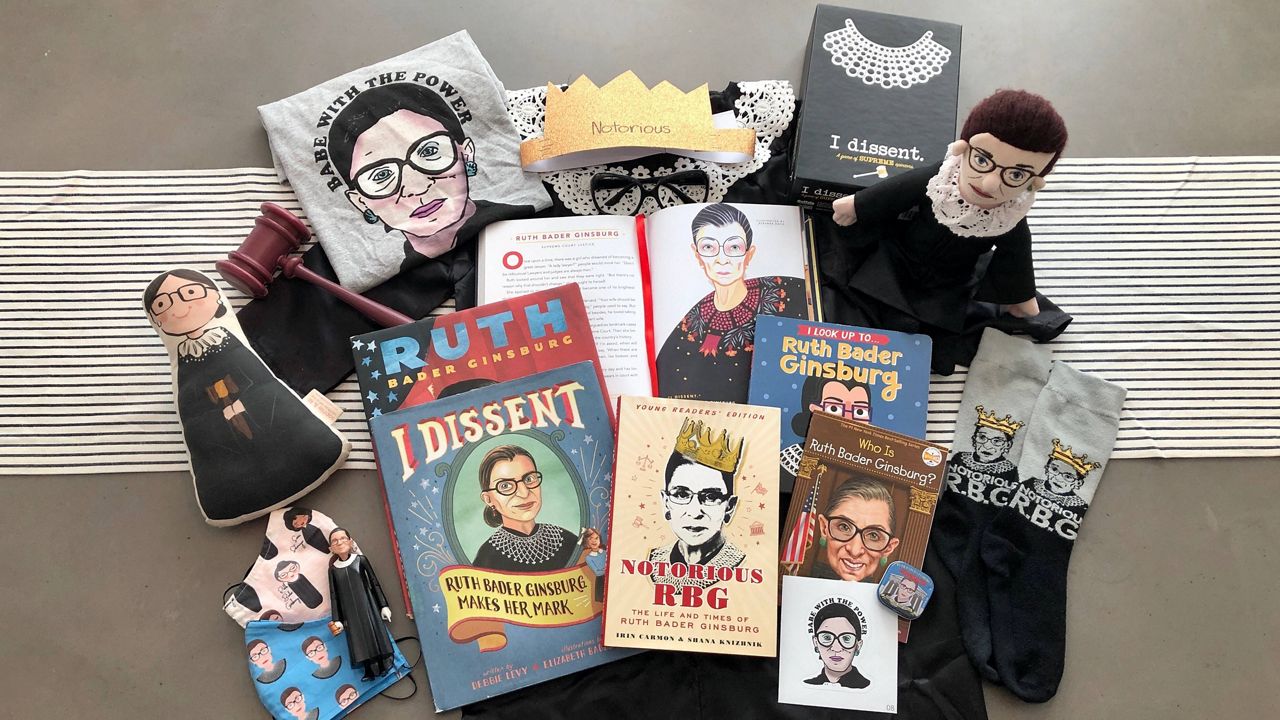A collection of RBG books, comic books, toys, and dolls.