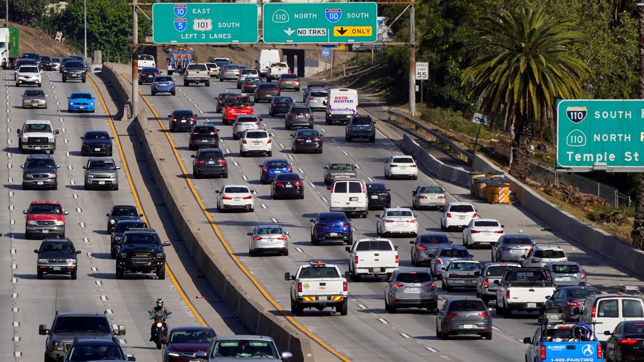 Traffic, at right, heads toward downtown along the 101 freeway, Thursday, April 16, 2020, in Los Angeles. (AP Photo/Mark J. Terrill)