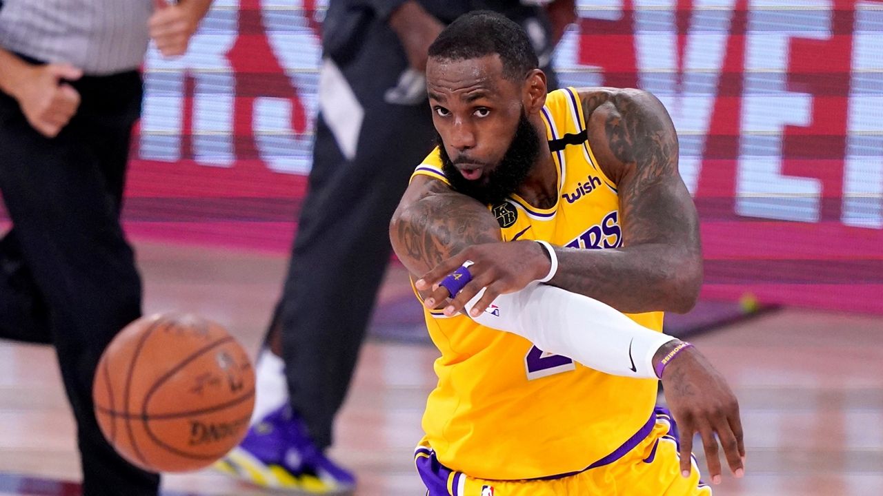 Los Angeles Lakers forward LeBron Jame makes a pass during the second half an NBA conference final playoff basketball game against the Denver Nuggets on Friday, Sept. 18, 2020, in Lake Buena Vista, Fla. (AP Photo/Mark J. Terrill)