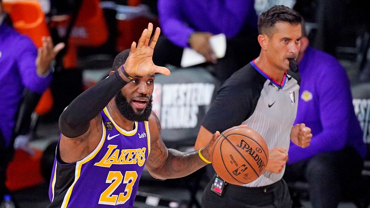 Los Angeles Lakers' LeBron James (23) brings the ball up the court during the second half of an NBA conference final playoff basketball game against the Denver Nuggets Saturday, Sept. 26, 2020, in Lake Buena Vista, Fla. (AP Photo/Mark J. Terrill)