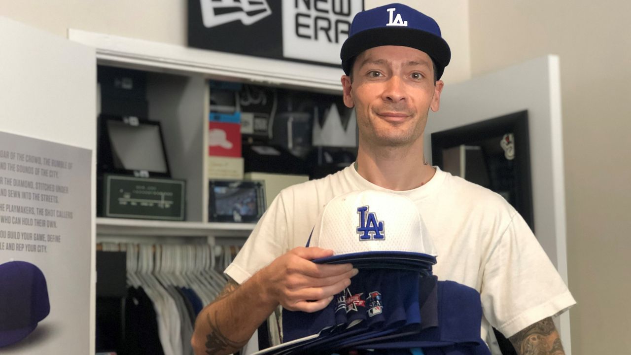 Dodgers Cap Collector Has Rally Hat On