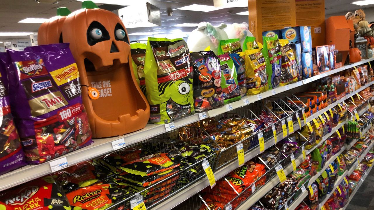 Halloween candy and decorations are displayed at a store, Wednesday, Sept. 23, 2020, in Freeport, Maine. U.S. sales of In this year of the pandemic, with trick-or-treating still an uncertainty, Halloween candy were up 13% over last year in the month ending Sept. 6, according to data from market research firm IRI and the National Confectioners Association. (AP Photo/Robert F. Bukaty)