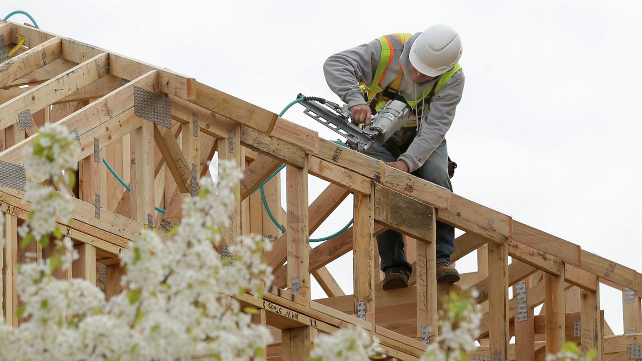 In this photo file photo from Feb. 8, 2019, work is done on an apartment building under construction in Sacramento, Calif. (AP Photo/Rich Pedroncelli, File)